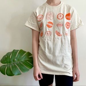 Cream t shirt with orange screenprint graphic